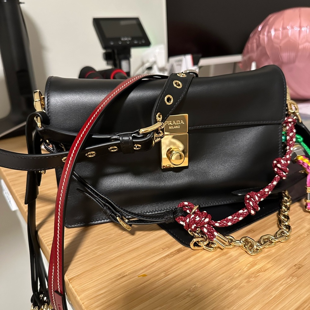 Brand new Prada Black Leather Crossbody Bag with Gold Accents and charms